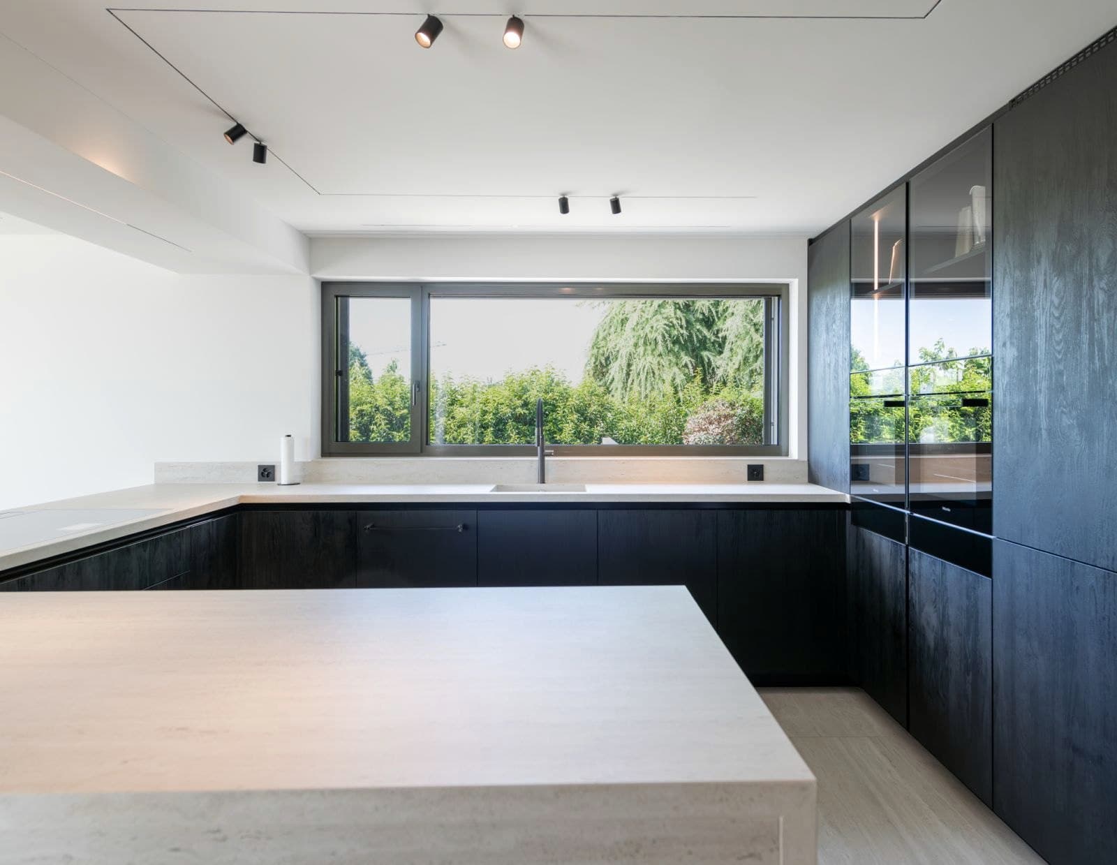 Villa: Küche in Schwarz mit heller Steininsel
